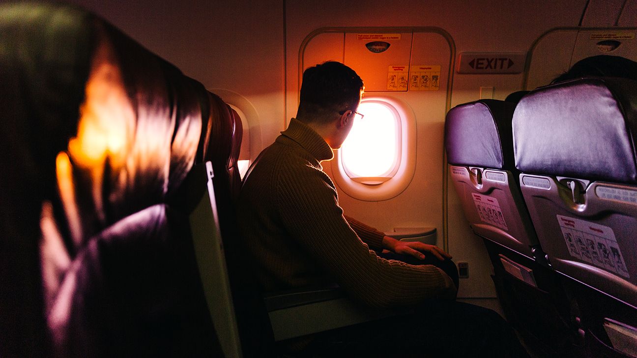 passenger sitting on airplane looking out the window