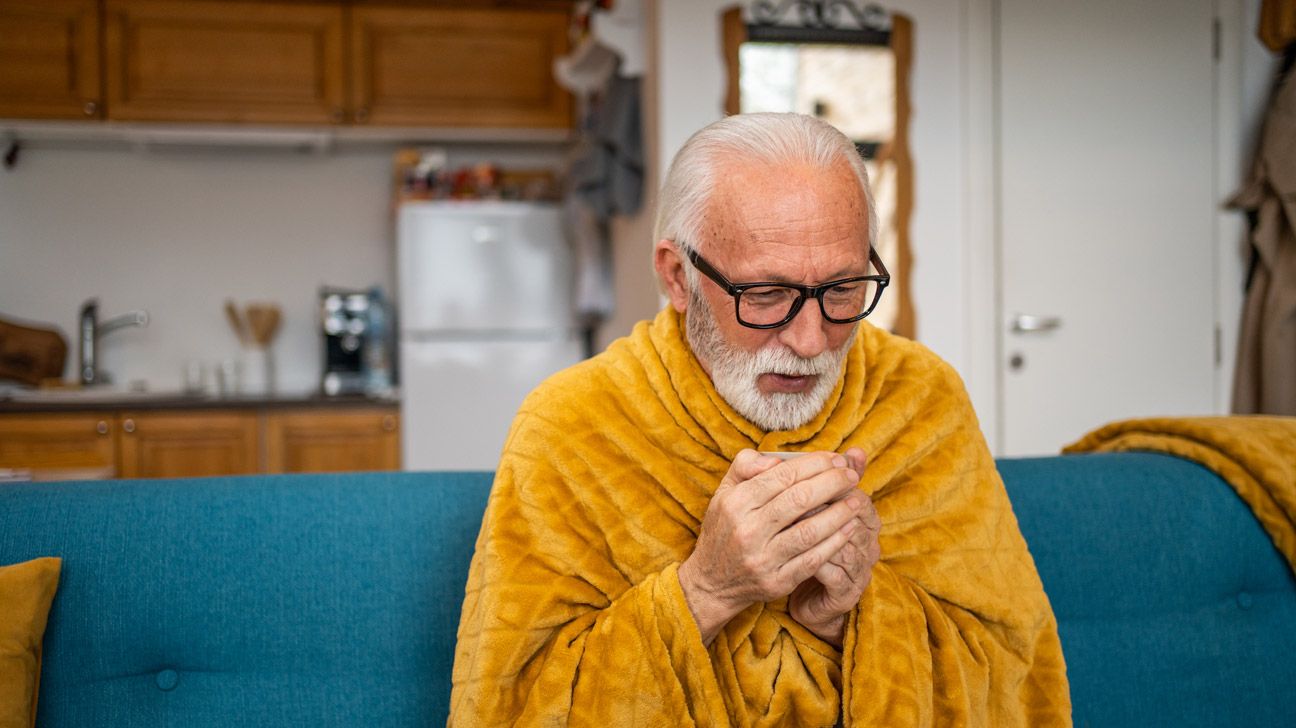 older person with stage 3 NSCLC sitting under a blanket-1