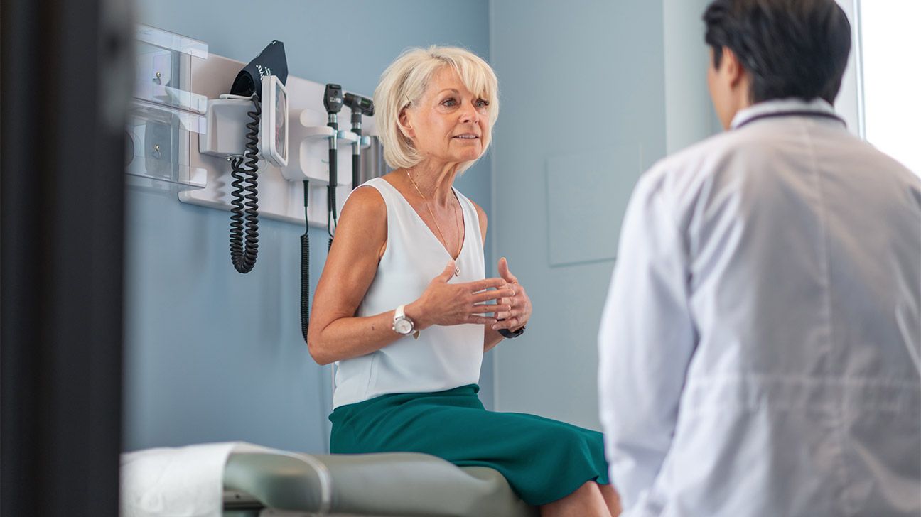 An older woman speaks with a doctor
