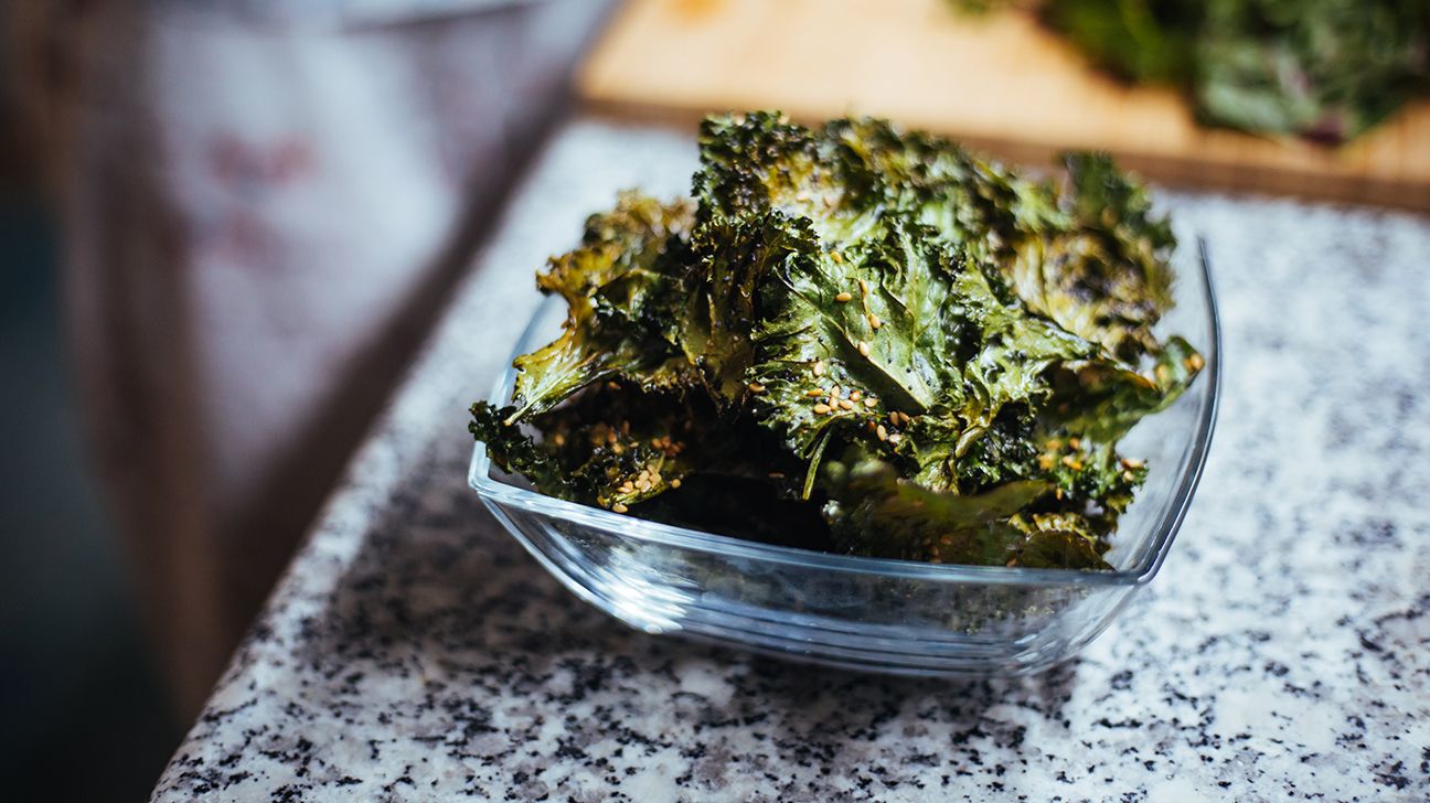 Bowl of seasoned kale on countertop