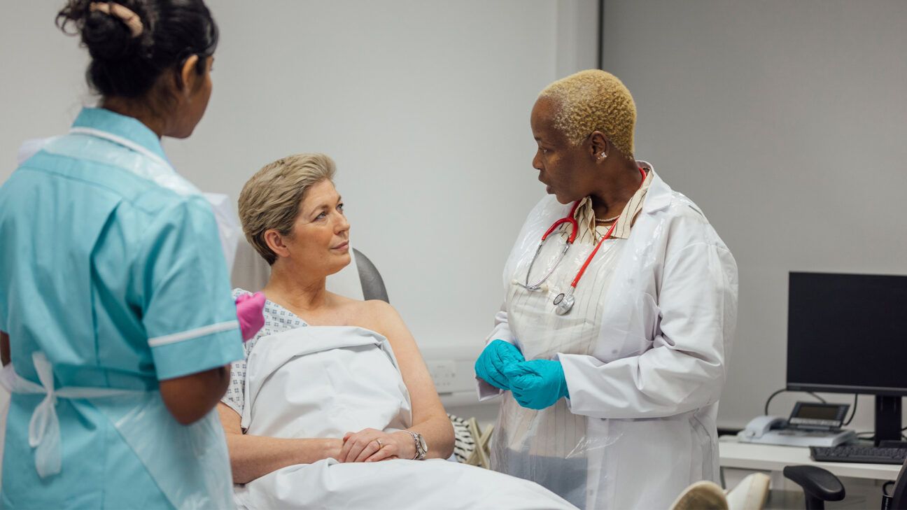 A female talking with a doctor before a breast cancer screening.