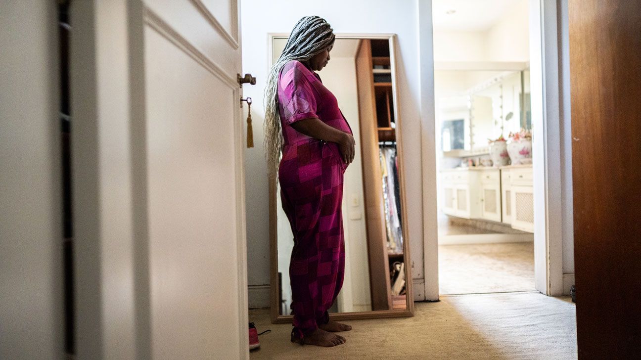 person with cardiomyopathy during pregnancy standing with hands on their stomach-1