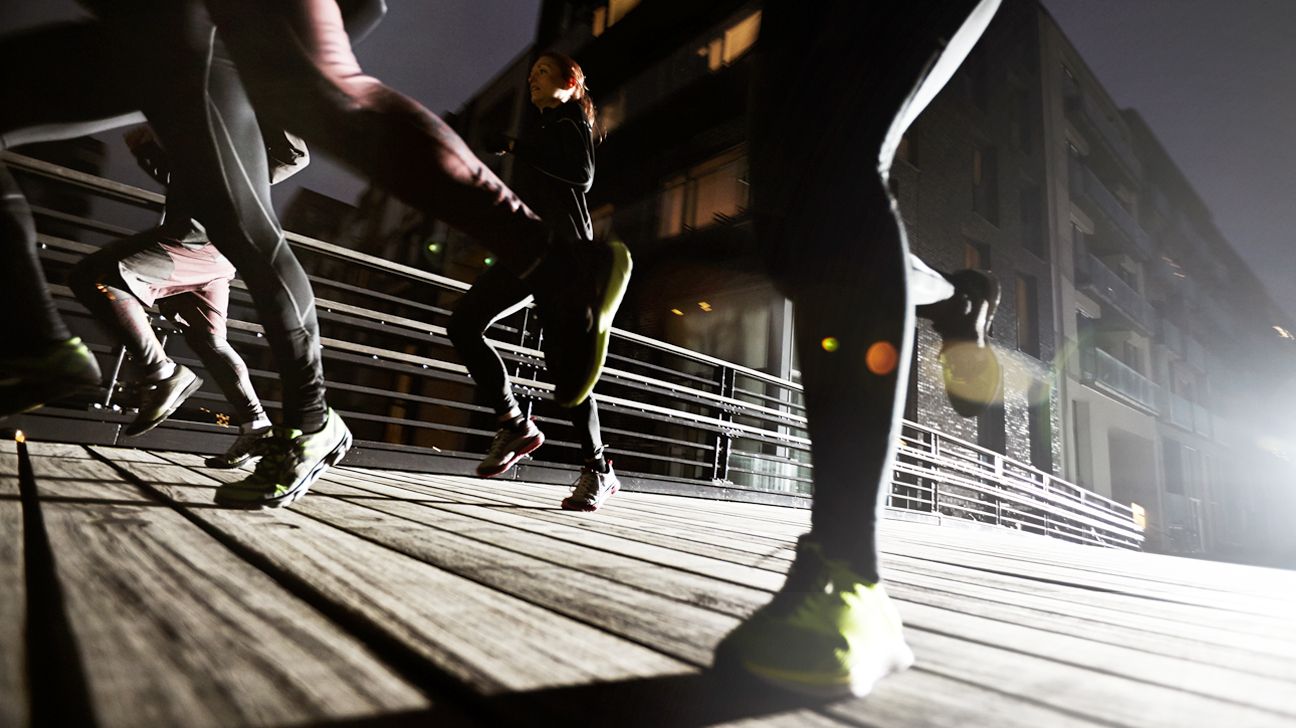 Group of people running at night.