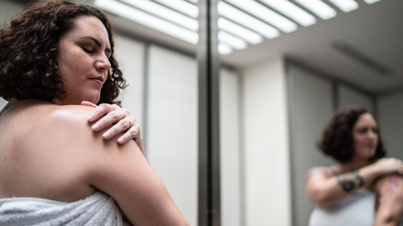 person checking their skin for benign skin tumors-1