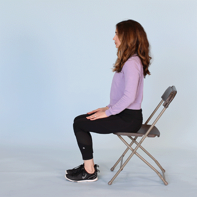 female performing seated leg extension with no weights