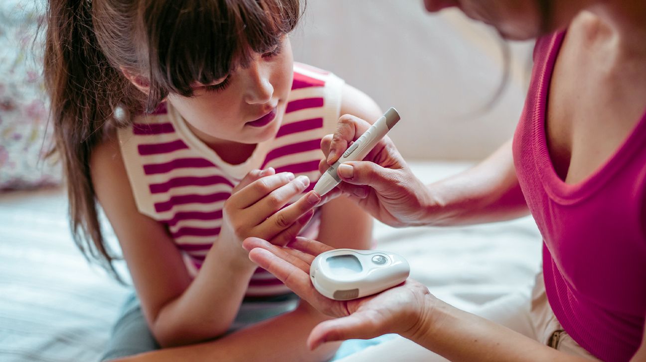 mother checking their child's blood sugar-1