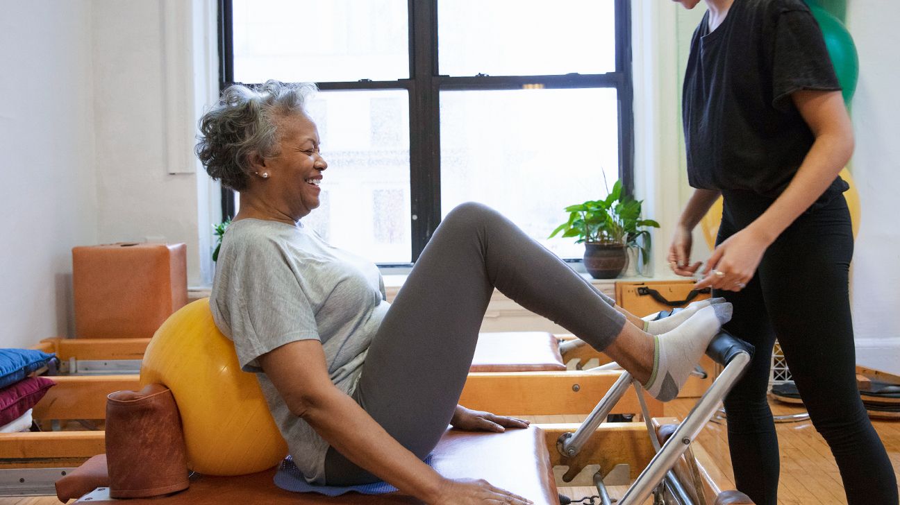 Older black female adult performing physical therapy exercise