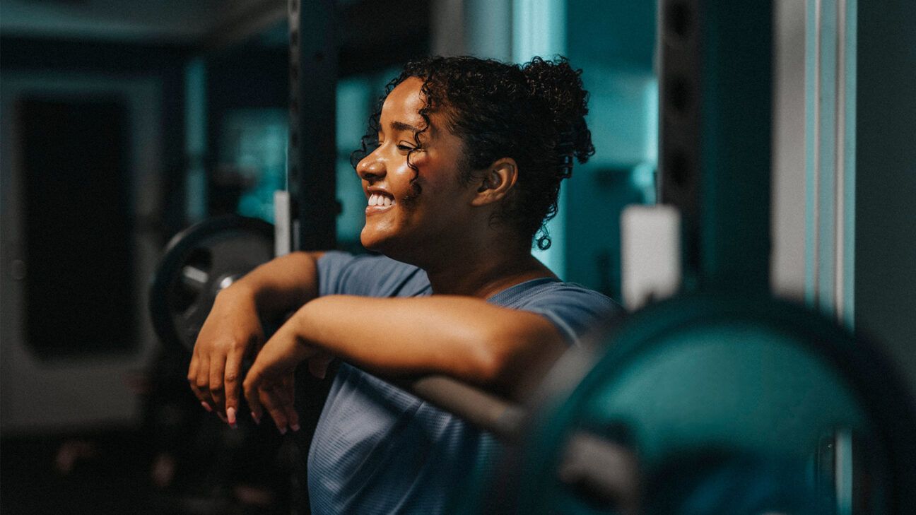 Woman smiles in a gym.