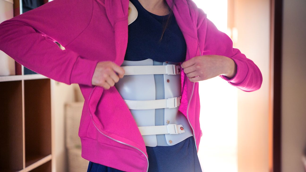A person wearing a spinal brace.