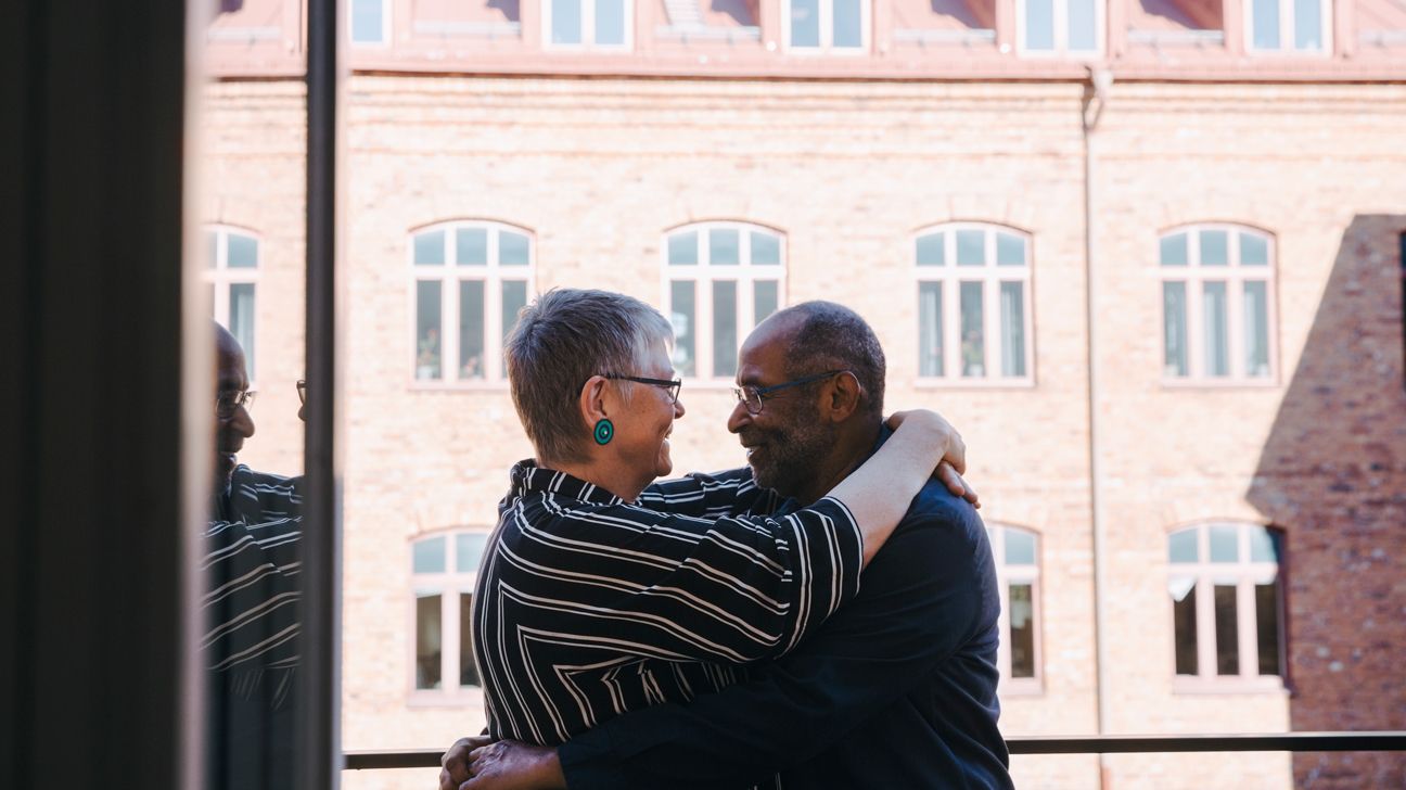 An older couple embracing.