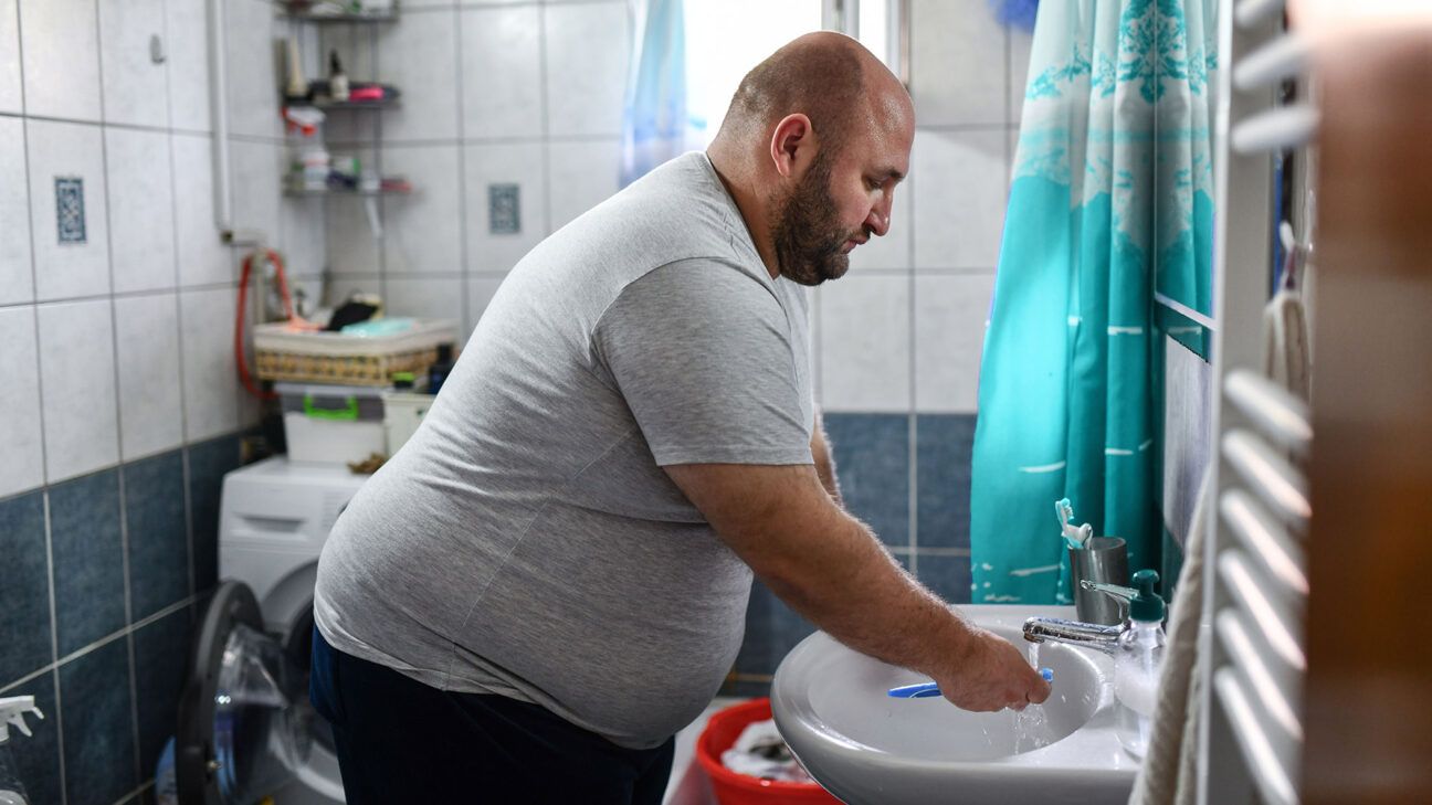 A man brushing his teeth.