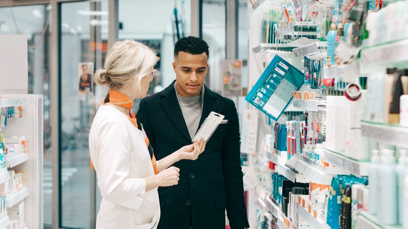 Pharmacist explaining the side effects of a medication to a person taking a new medication.