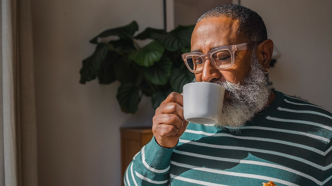 Older adult with hypothyroidism drinking coffee