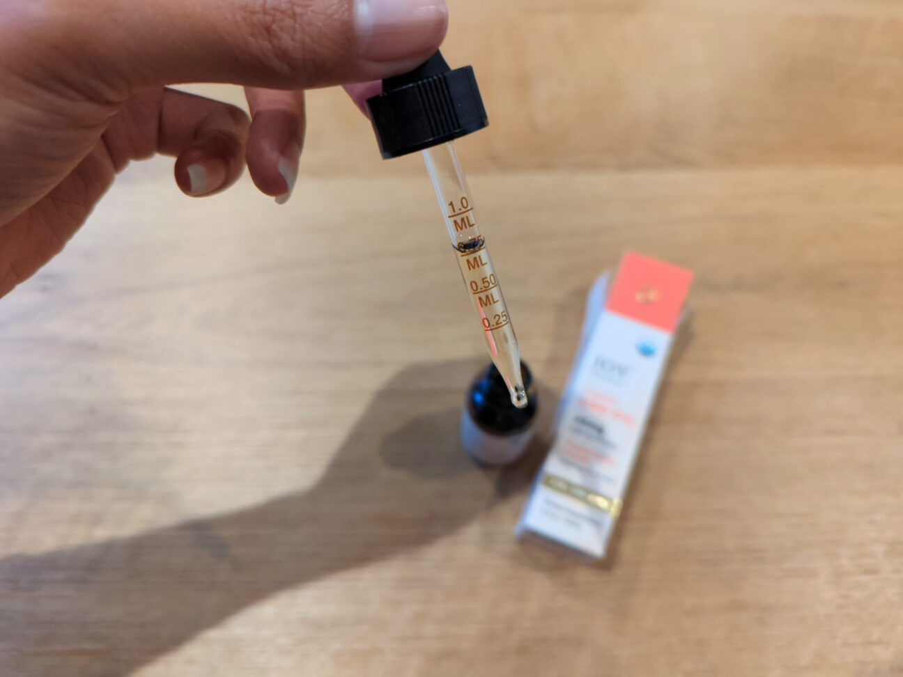 a Healthline tester showing how to use a CBD oil dropper