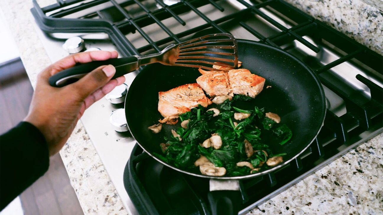 Cooking chicken and vegetables in a pan.