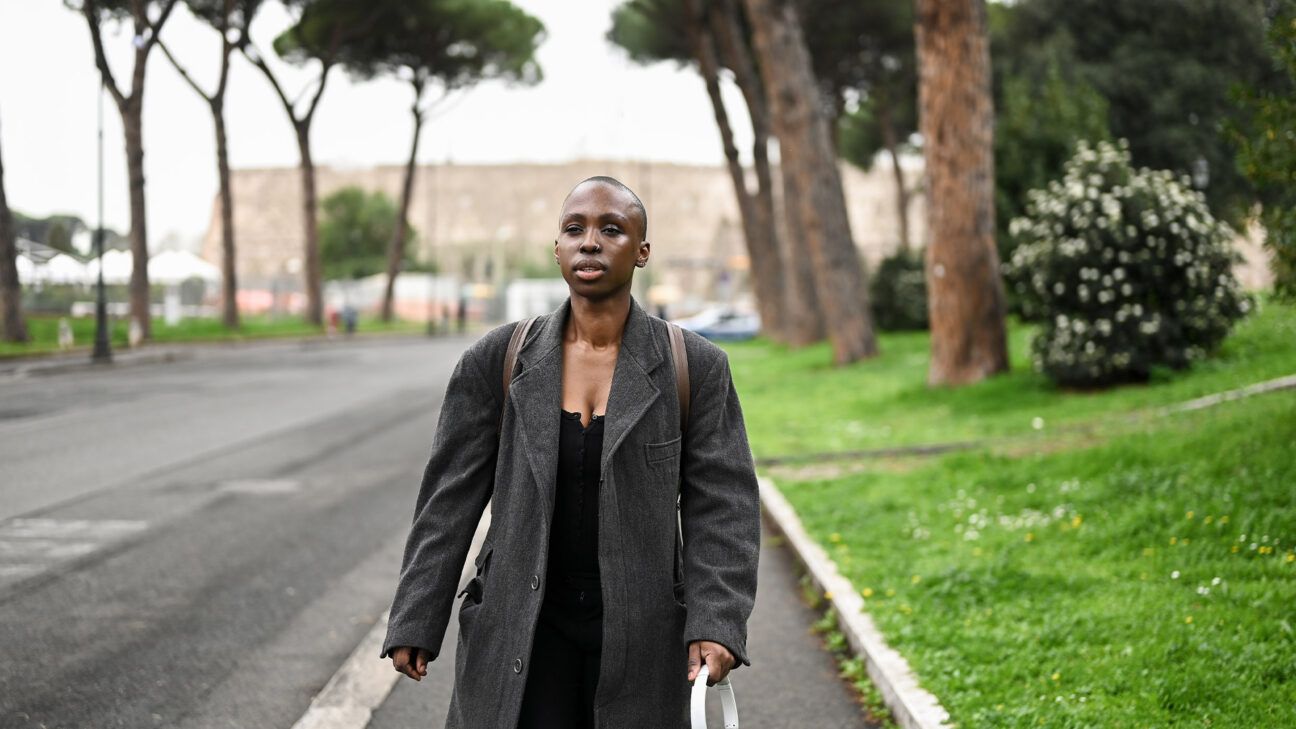 Woman with jacket seen walking outside.