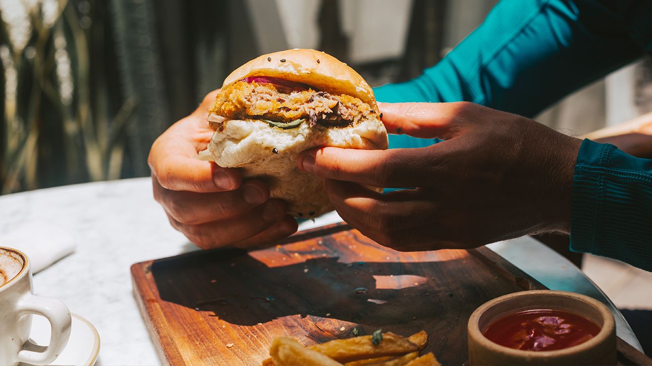 A person holding a vegan burger.