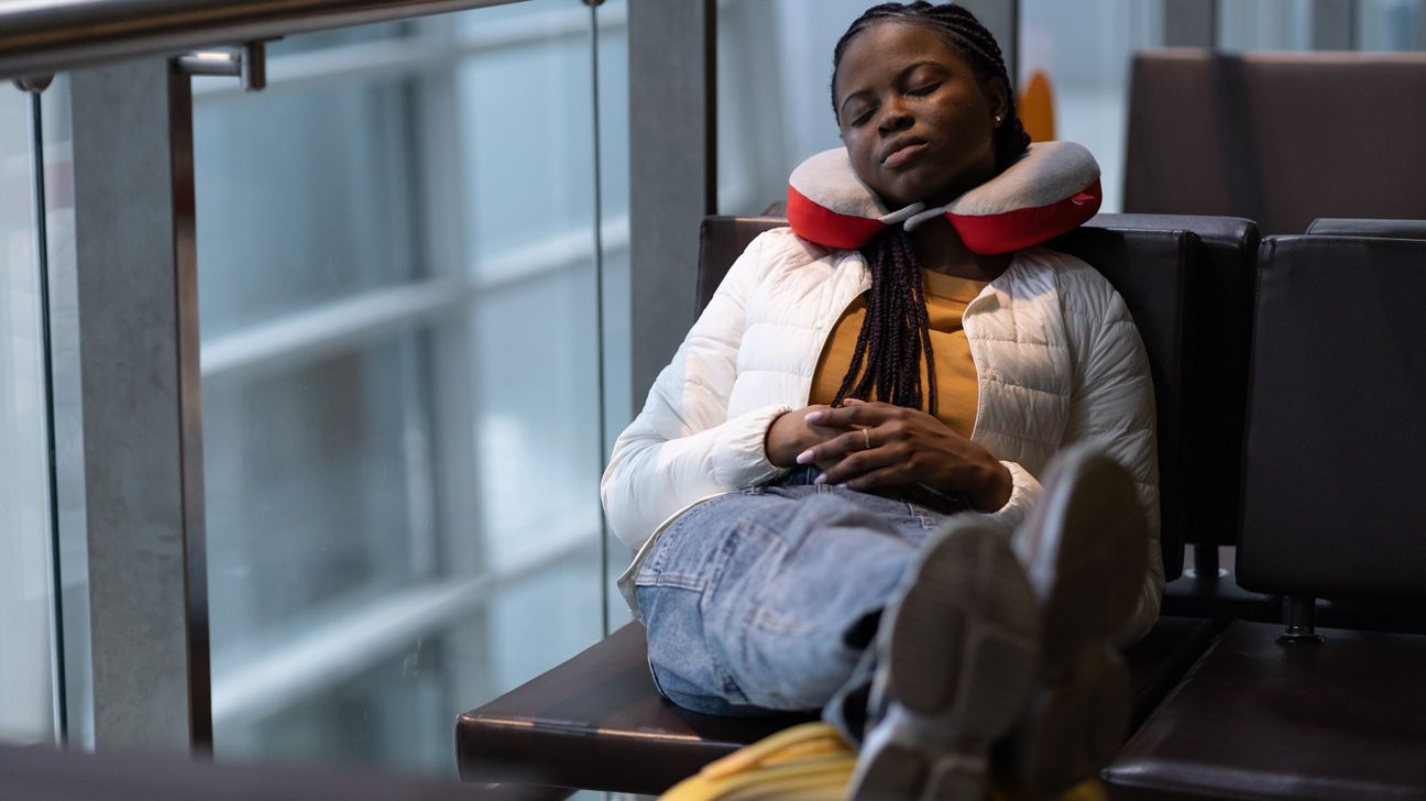 Woman resting with travel pillow 