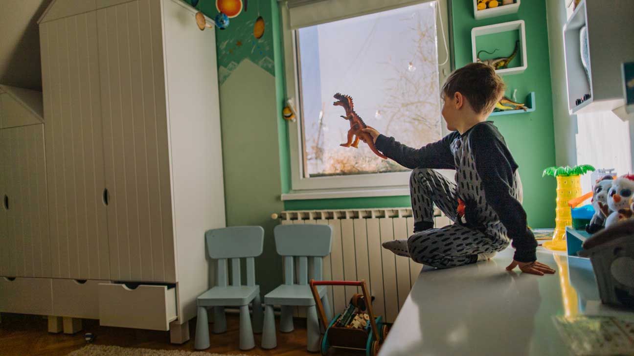 Boy playing in room with toys