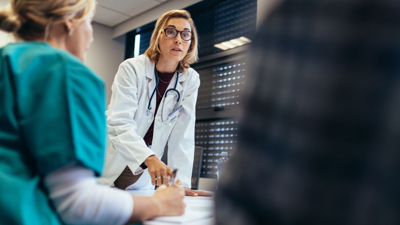 female doctor talking with patient and nurse