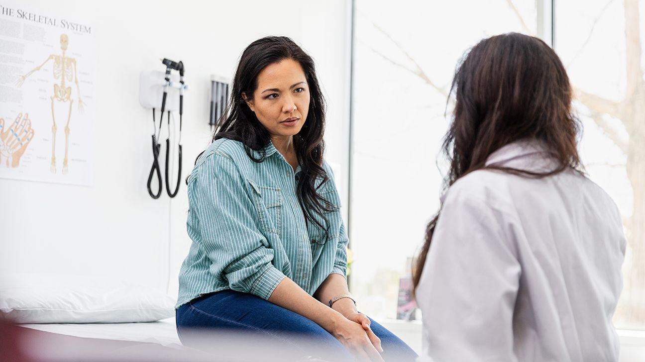 Female talking to doctor in office