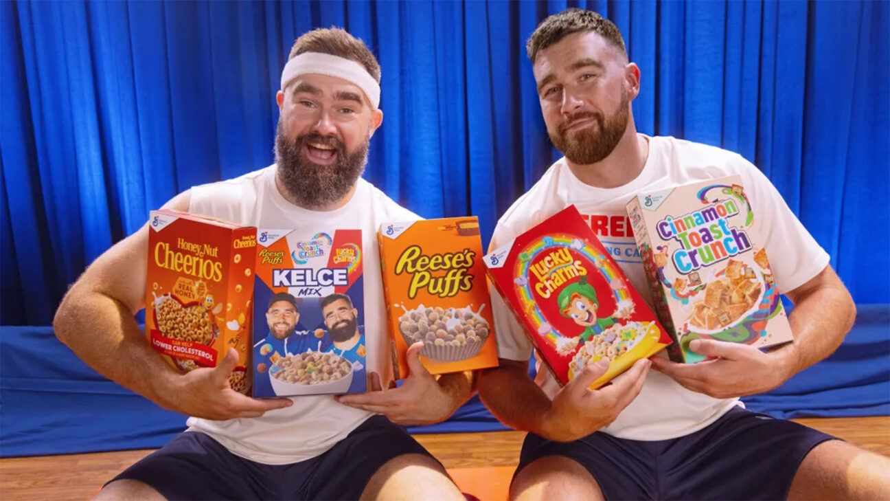 Travis and Jason Kelce holding boxes of cereal.