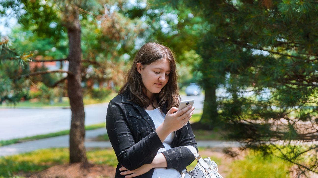 Female looking at a smartphone.