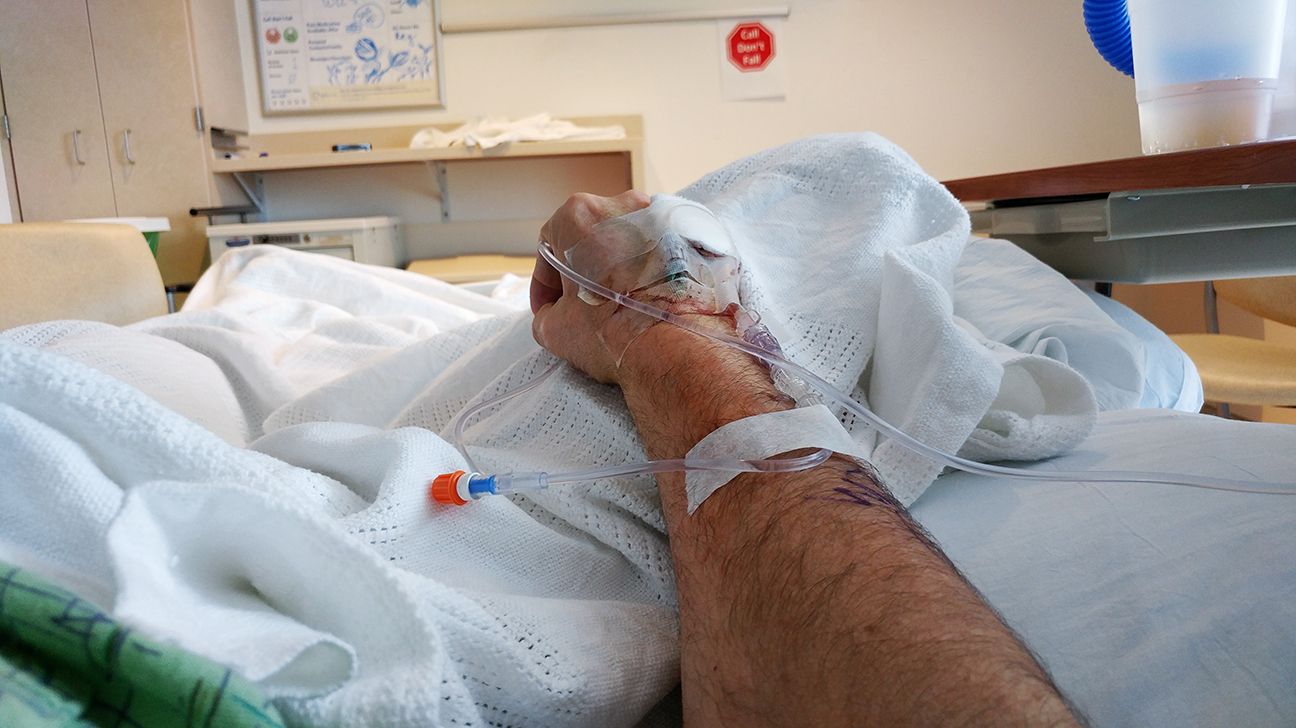 A cancer patient in the hospital with an IV drip in their arm