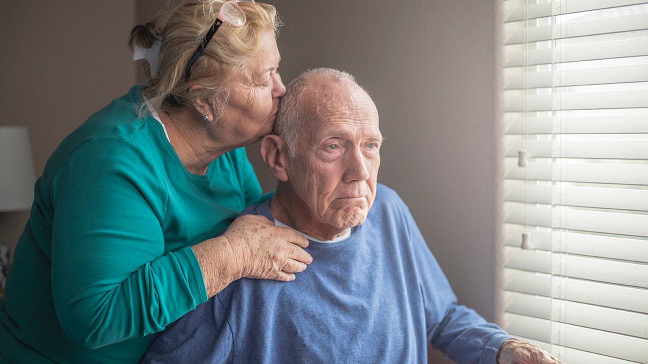 Woman kissing her husband with dementia behaviors