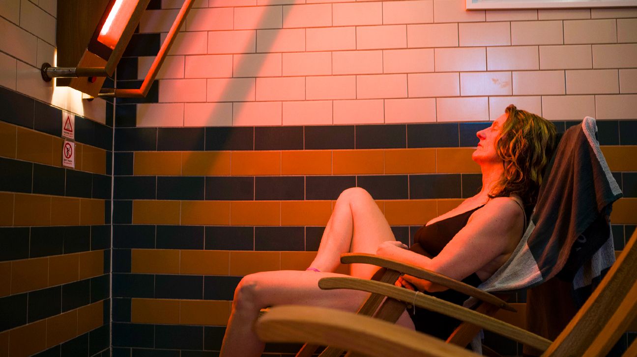 A woman sitting in an infrared sauna.