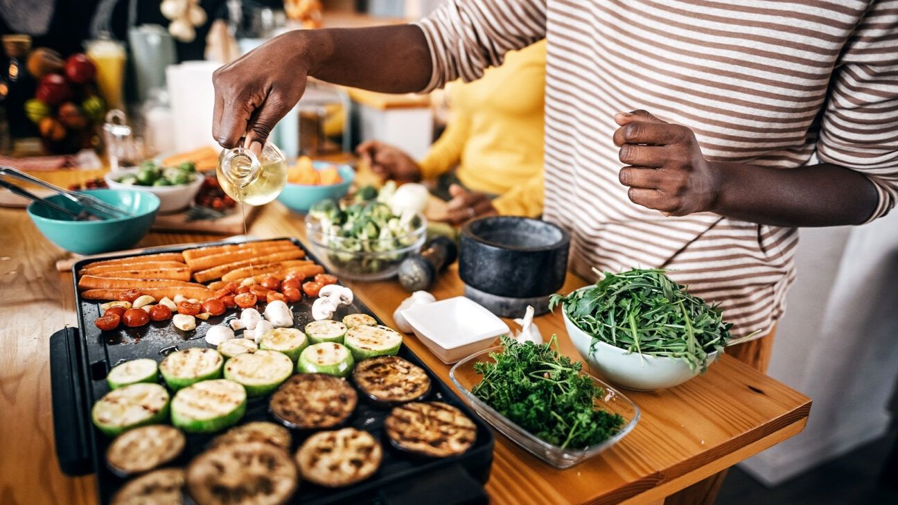 A person cooking vegetables with olive oil..