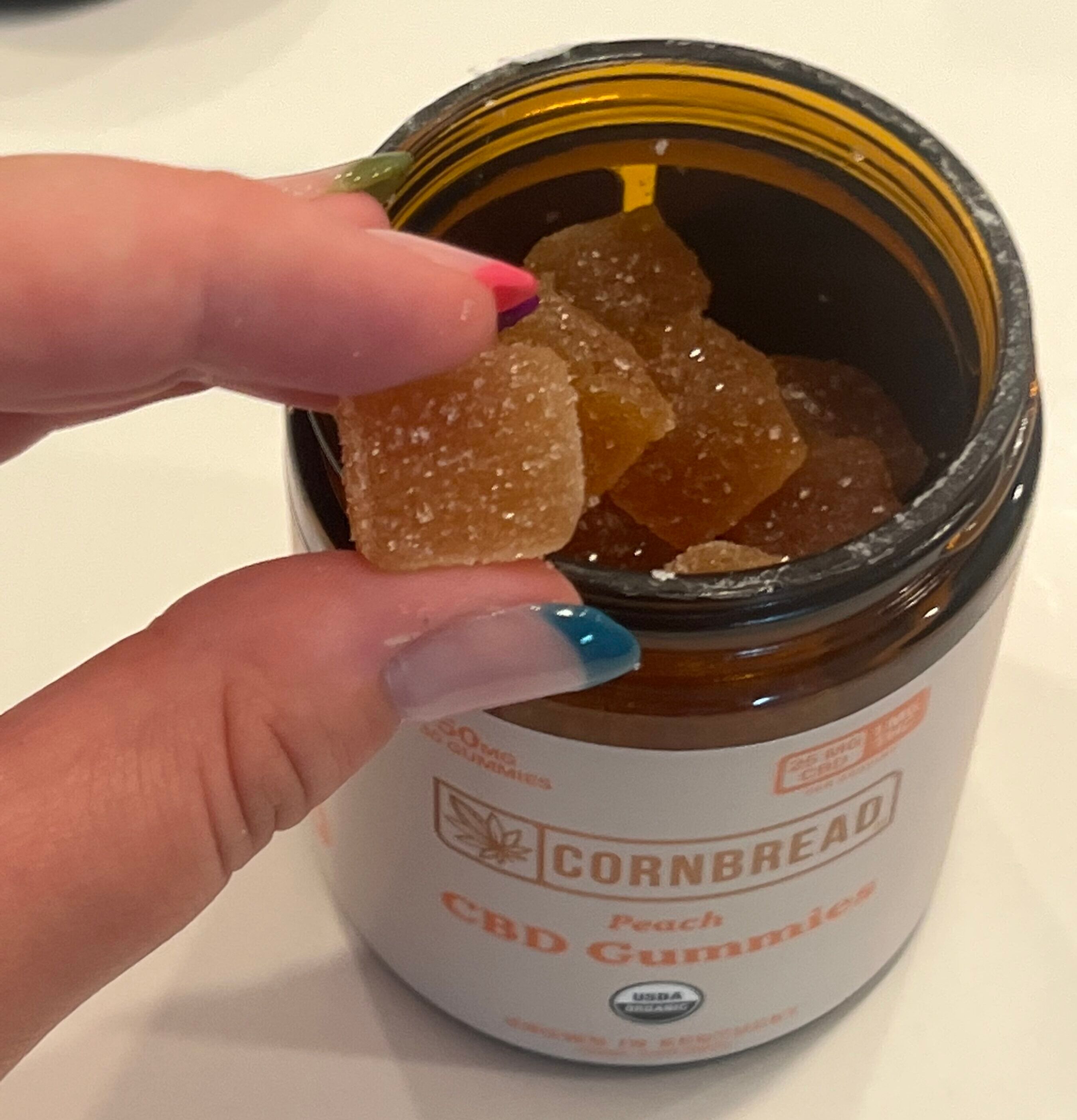 testing peach flavored CBD gummies by Cornbread Hemp