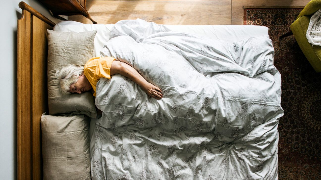 Older female sleeping in bed