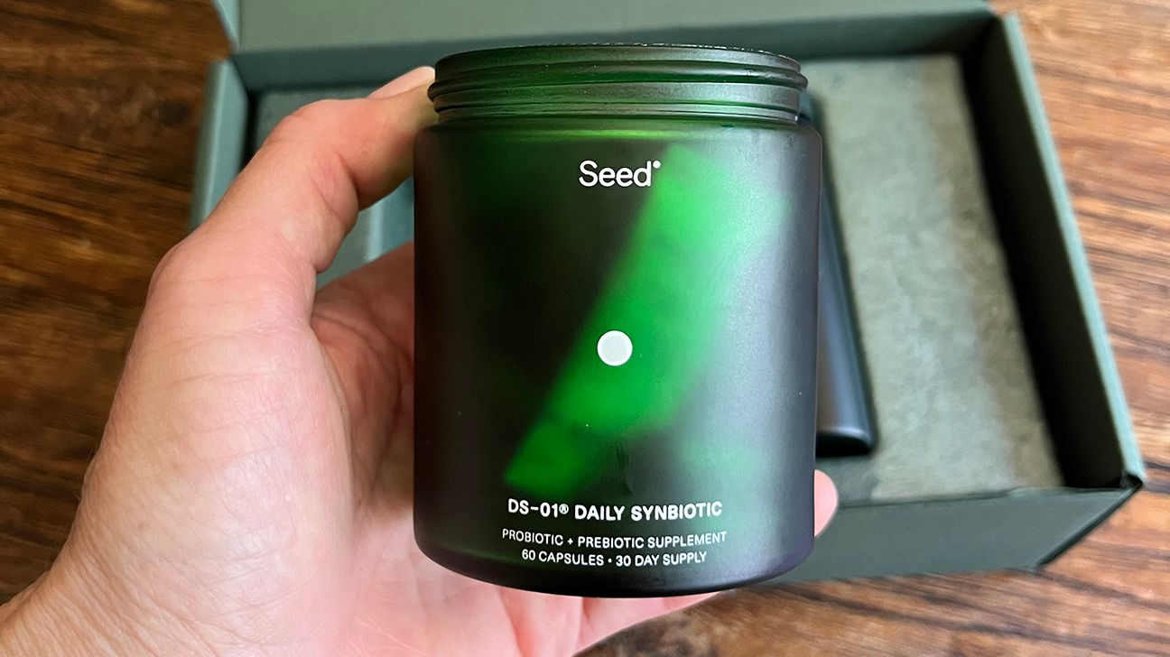 Tester hand holding Seed jar