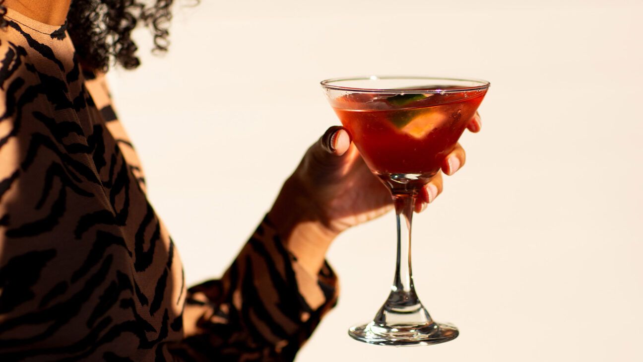 A person drinking a cocktail.