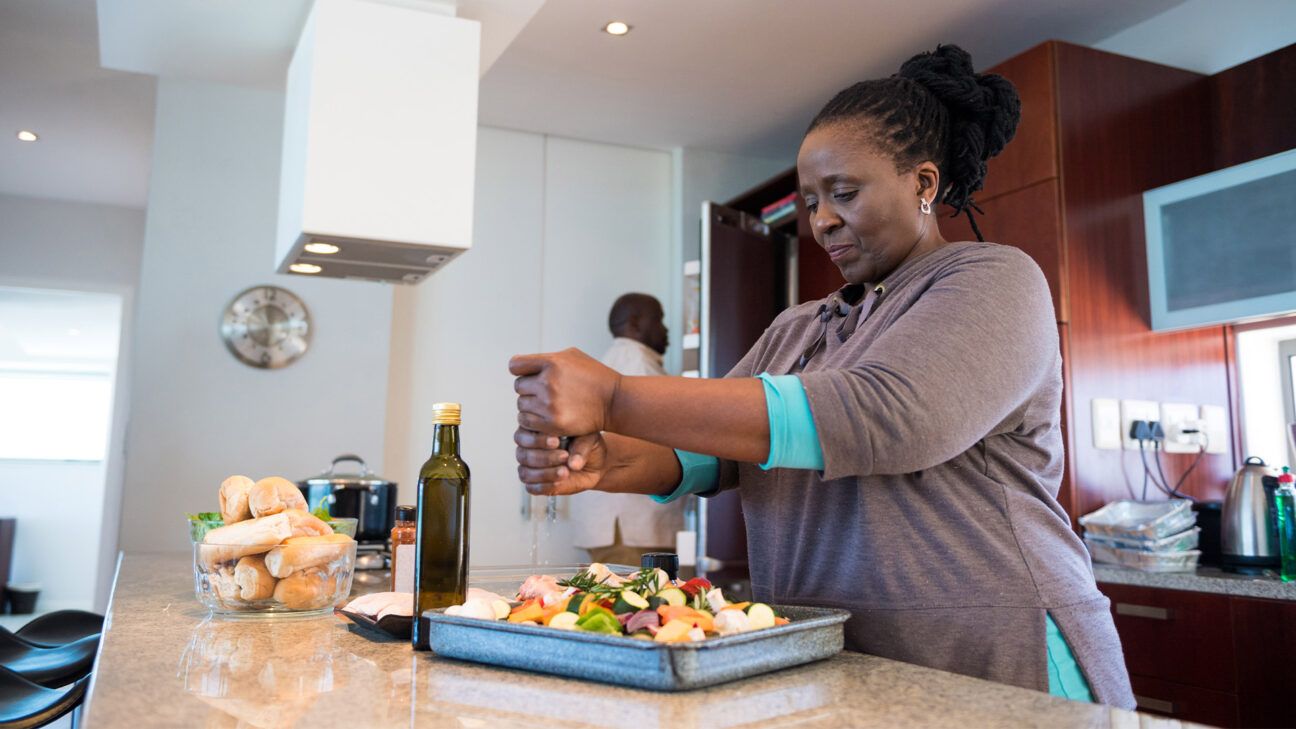 A female cooking in a kitchen.