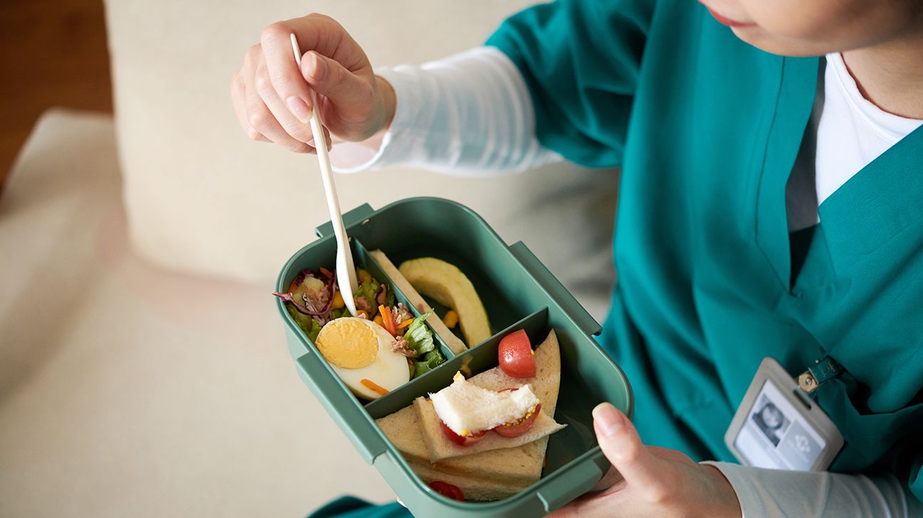 A female nurse eats her packed lunch