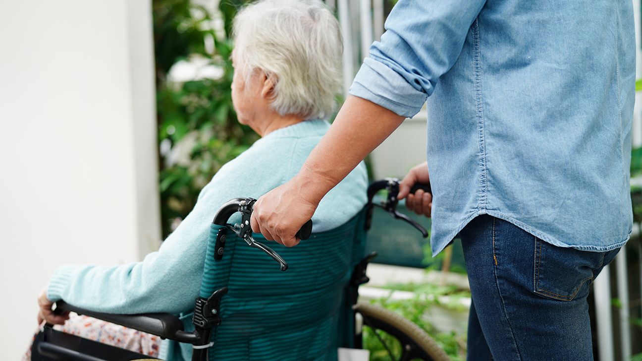 older person on Medicare being pushed in a wheelchair-1