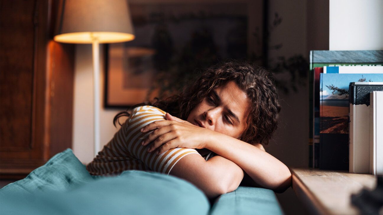 tired female adult resting with head on her arms
