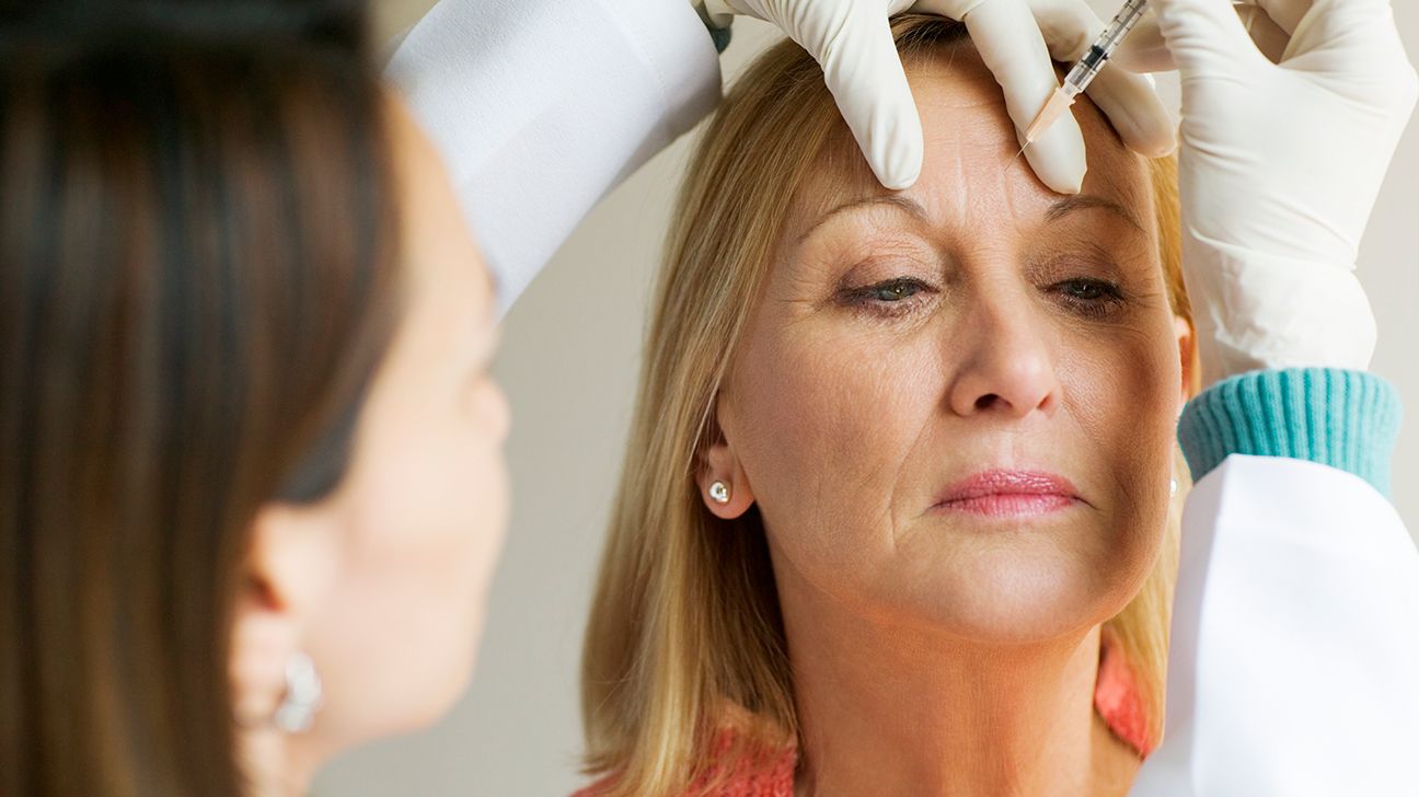 woman receiving botox injection in forehead