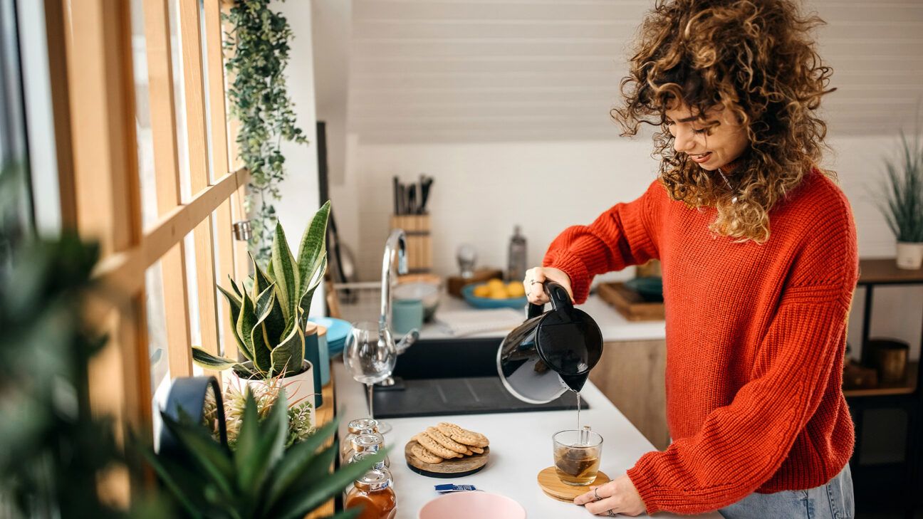 A female pouring tea.