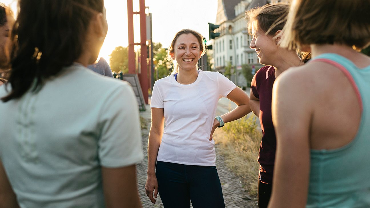 Female standing outside with workout group
