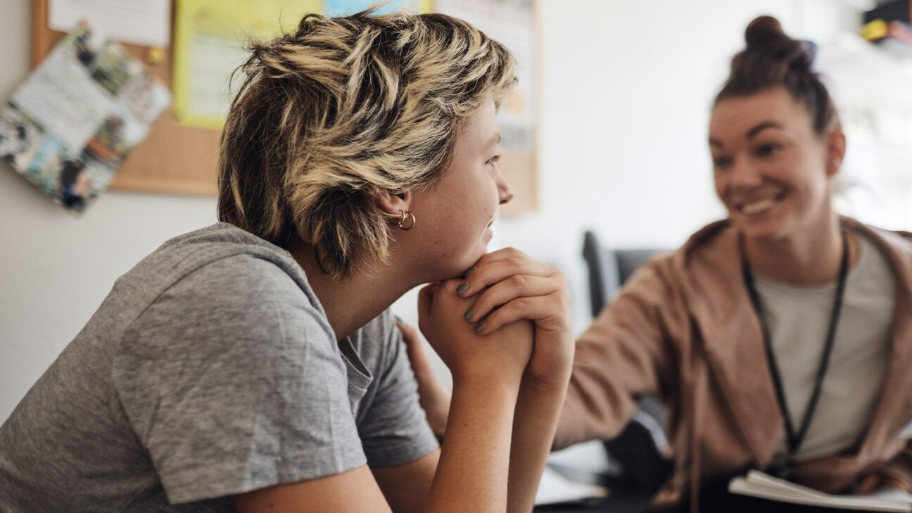 Two females sitting at a table.