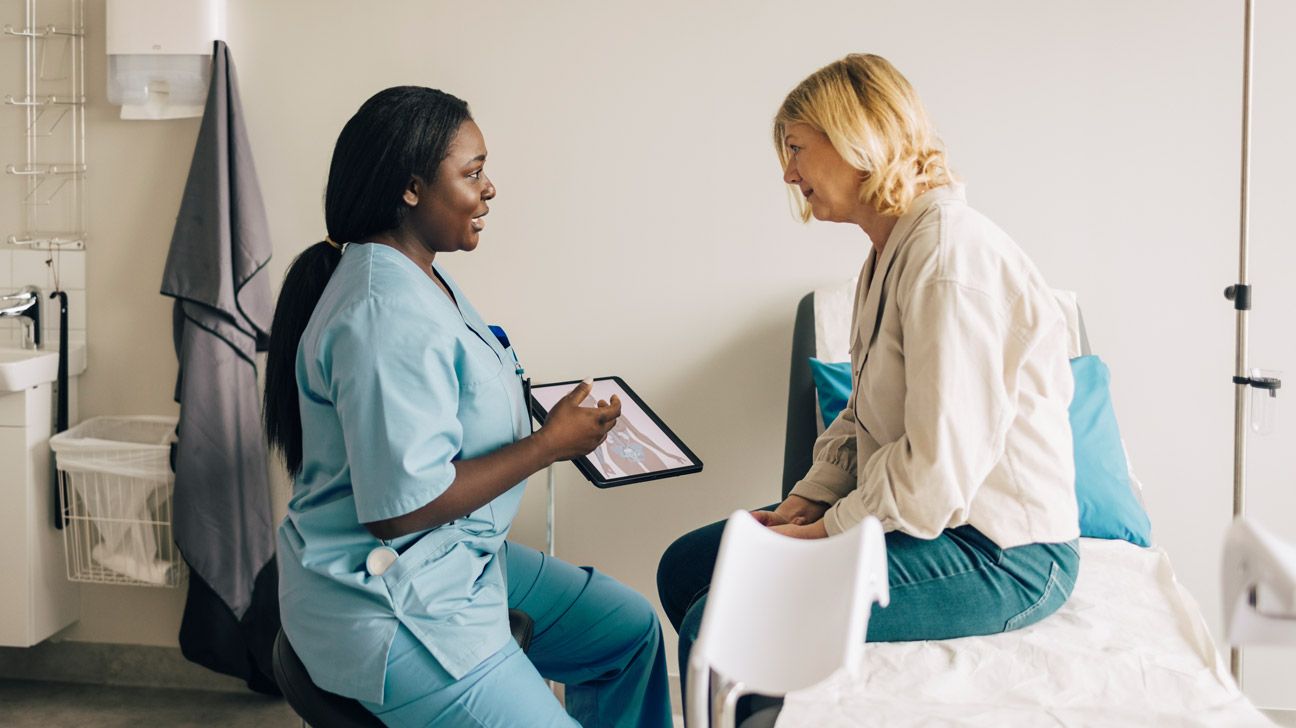 woman with nurse during gynecologist visit
