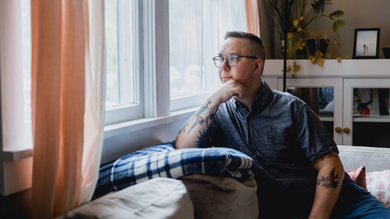 A person sitting and looking out a window