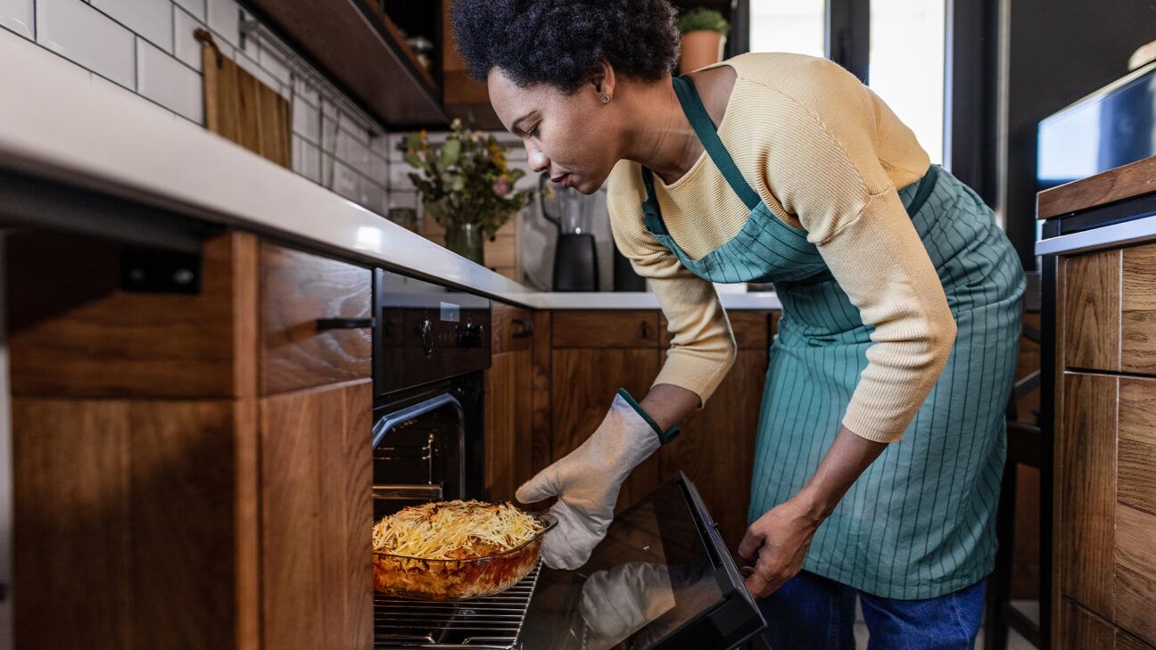 A female cooking mac and cheese.