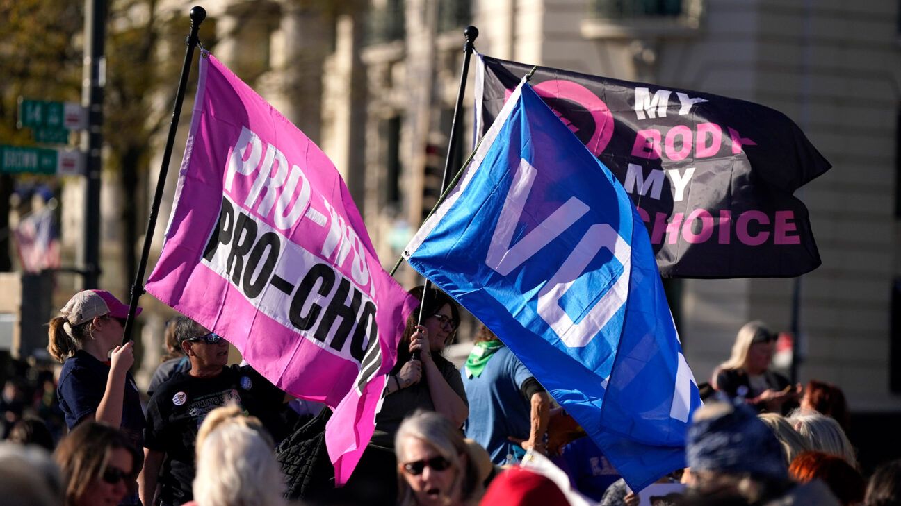 protesters holding abortion rights-related flags