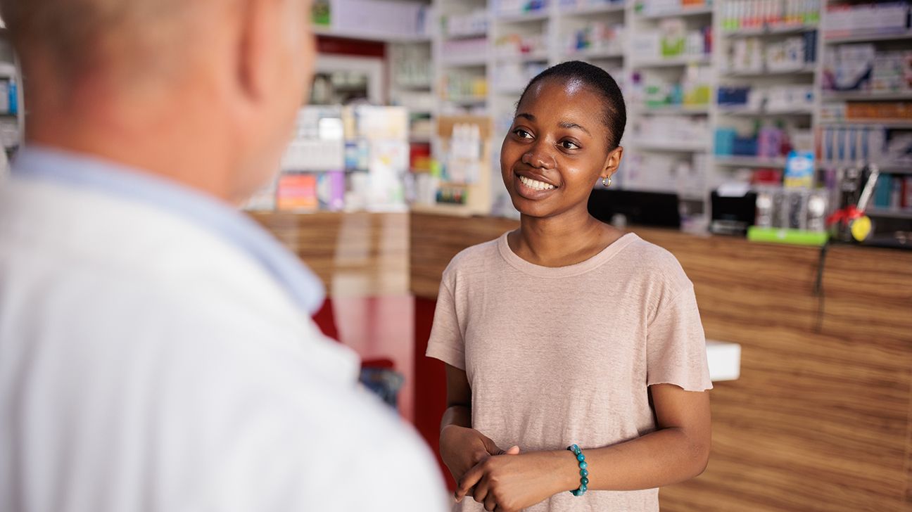 young woman talking with pharmacist