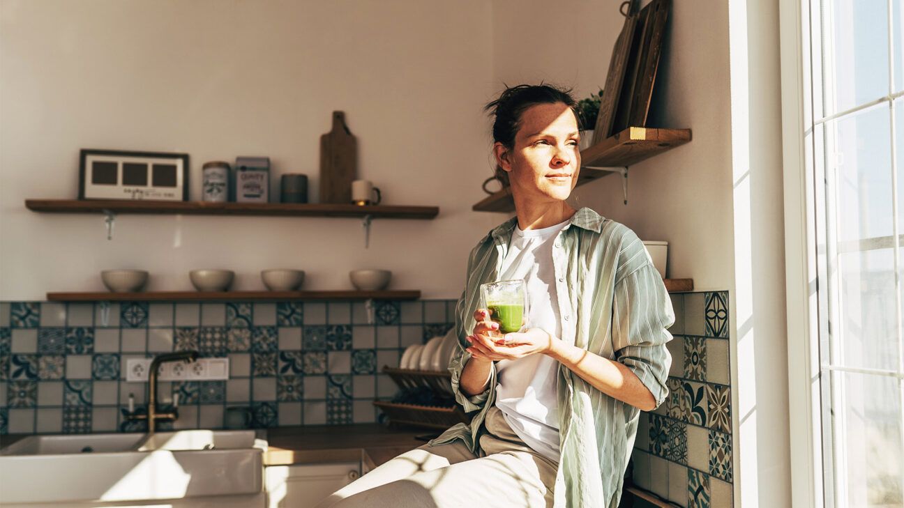 Woman drinks green smoothie