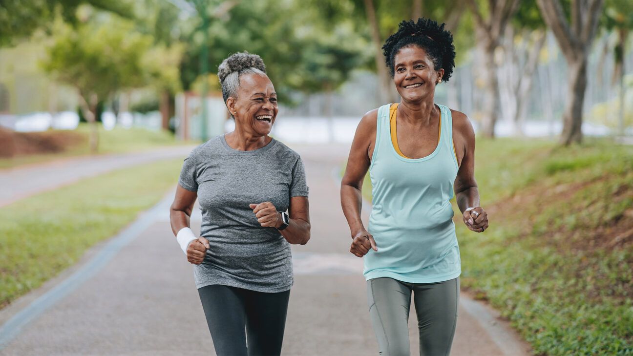 Two older females jogging outdoors